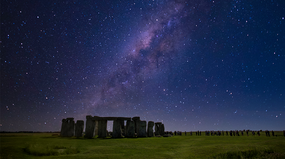 Stonehenge at night with starry sky on winter solstice.